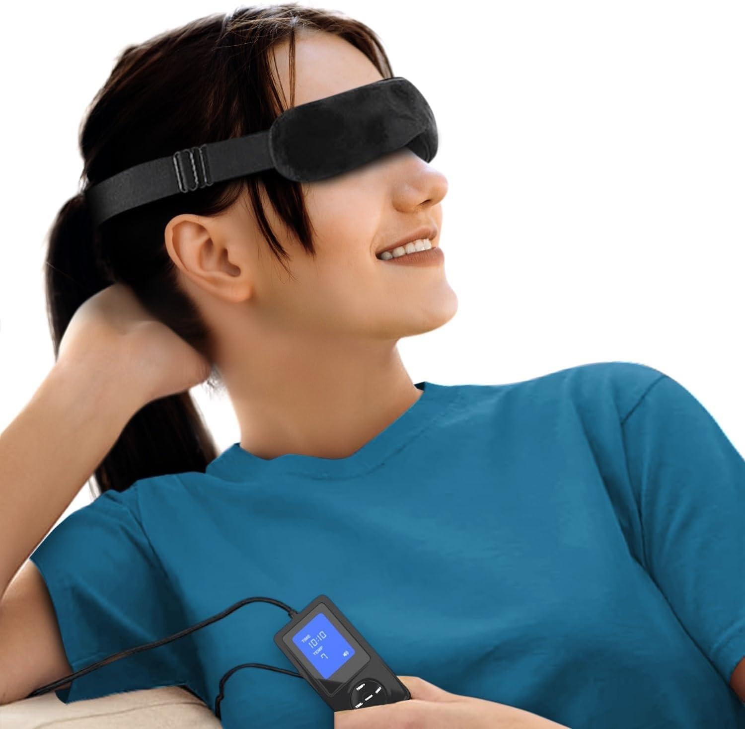 Young woman lying down wearing a dark grey heated eye mask with a control panel, appearing relaxed