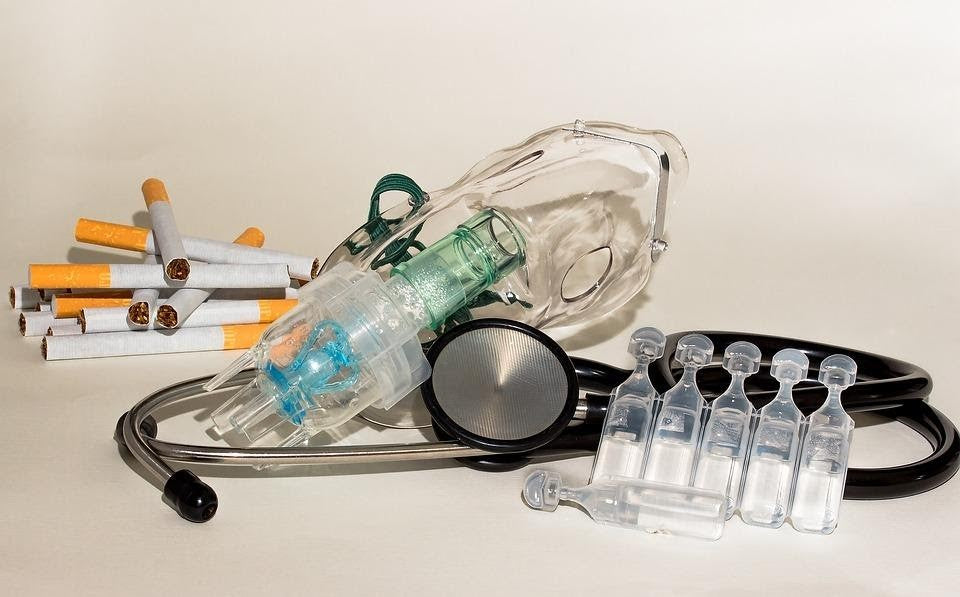 Portable nebulizer machine with mask, tubing, and medication vials on a table
