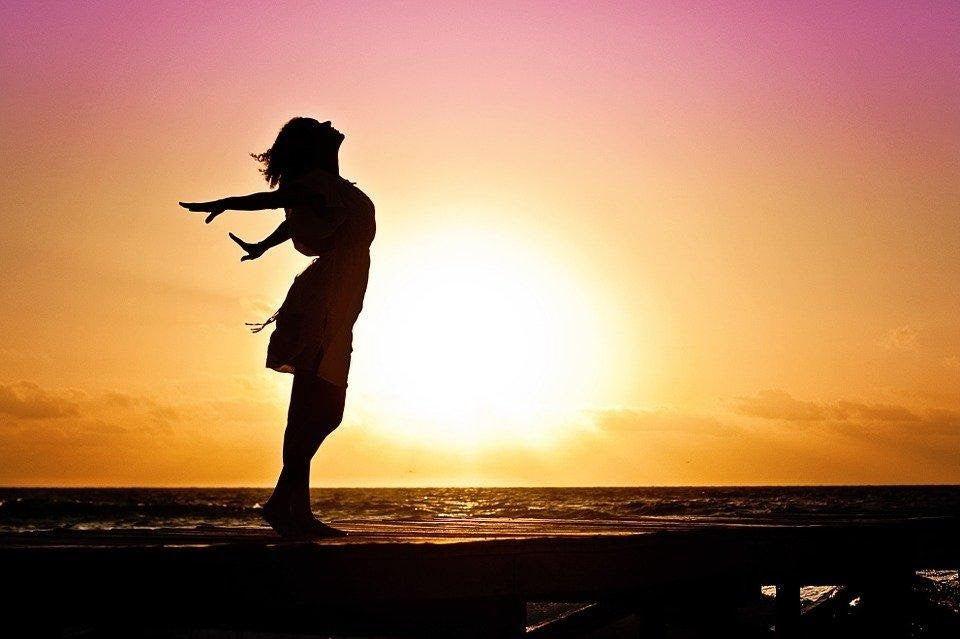 Child playing outdoors at sunset, breathing freely and enjoying fresh air