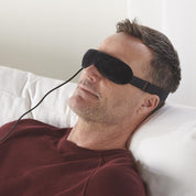 man relaxing wearing wizard research heated eye mask