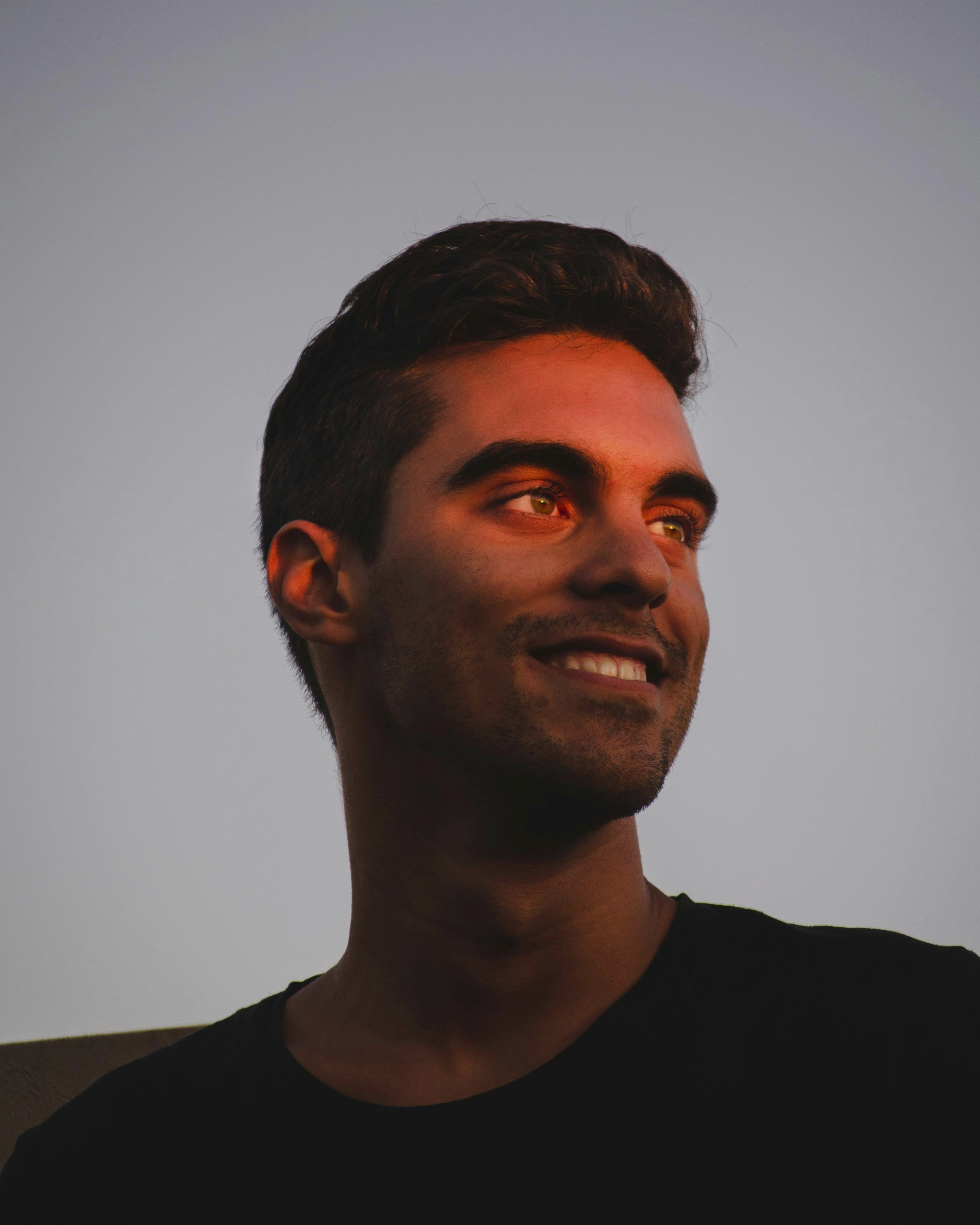 head and shoulders of man looking into sunset