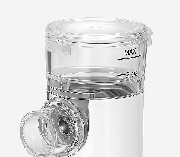 Clear nebulizer cup with 2 oz max fill markings shown on a white background